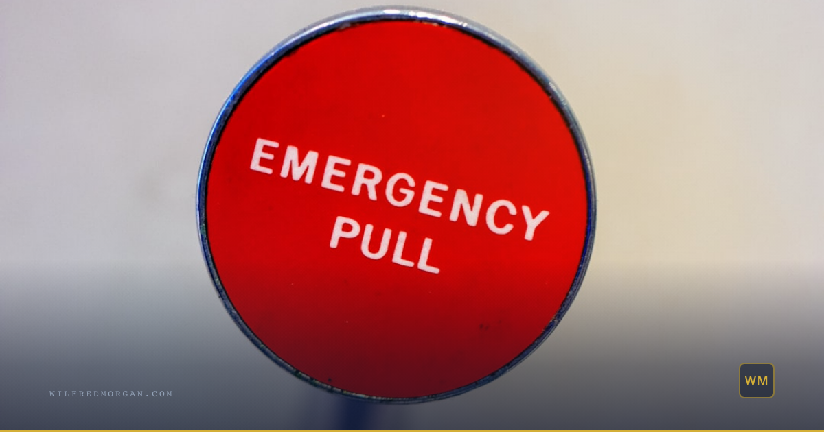 Scene: Industrial red emergency stop button on a metal control panel